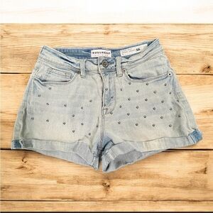 Bullhead Women’s Light Blue Denim Shorts With Studded Front.